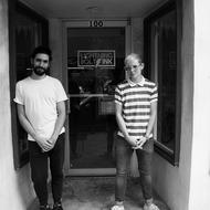 Graphic Designer Estbean Gonzalez and Owner SB in the doorway of Lightning Bolt Ink. Photo: Erin Fowler